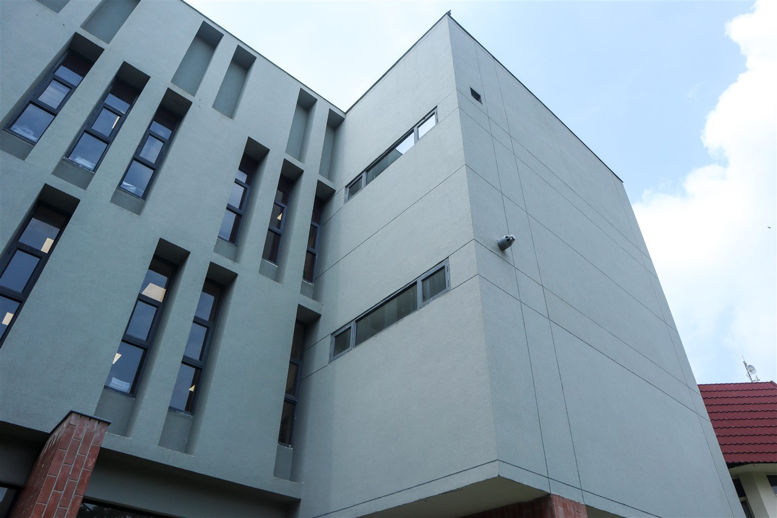 Luxstone natural stone texture finish on a contemporary institutional facade