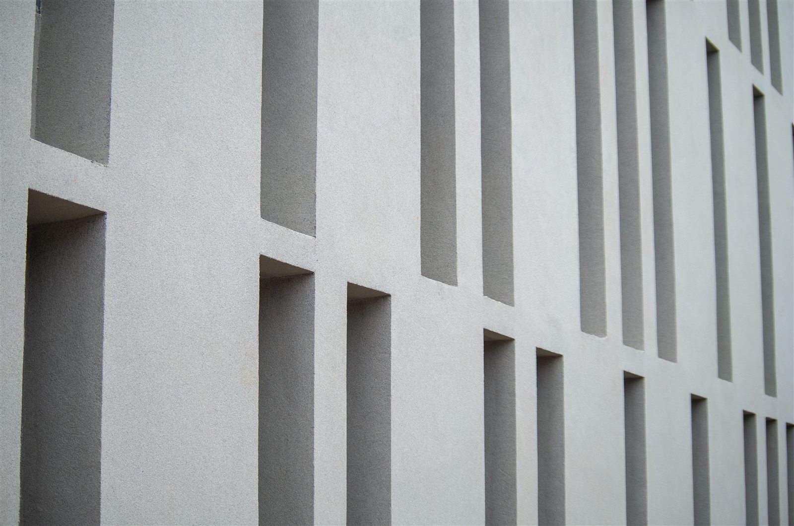 Institutional facade with repeated recessed architectural openings